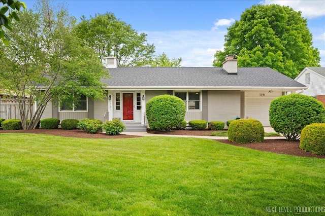 1731 Garfield Ave, Aurora, IL 60506 - view of front of home featuring a chimney, an attached garage, brick siding, and a front yard