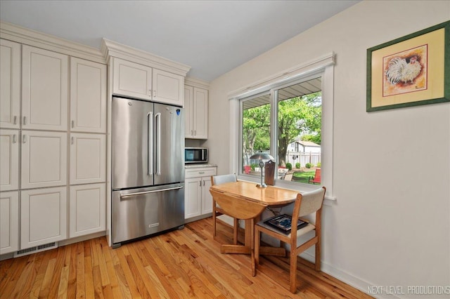 1731 Garfield Ave, Aurora, IL 60506 - kitchen with appliances with stainless steel finishes, light wood-type flooring, and baseboards