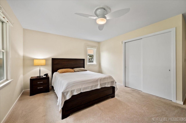 1731 Garfield Ave, Aurora, IL 60506 - bedroom with light colored carpet, baseboards, a closet, and ceiling fan