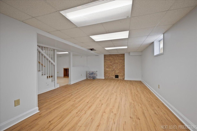 1731 Garfield Ave, Aurora, IL 60506 - below grade area featuring wood finished floors, a paneled ceiling, stairway, baseboards, and a fireplace
