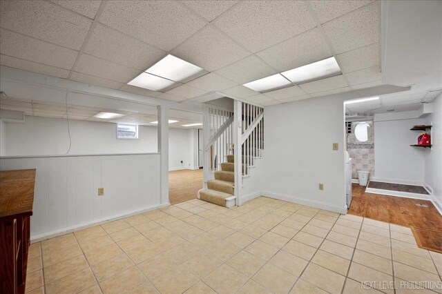 1731 Garfield Ave, Aurora, IL 60506 - below grade area featuring a drop ceiling, stairway, baseboards, and tile patterned flooring