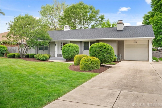 1731 Garfield Ave, Aurora, IL 60506 - view of front facade with a chimney, a garage, brick siding, concrete driveway, and roof with shingles