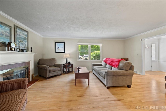 1731 Garfield Ave, Aurora, IL 60506 - living area with light wood finished floors, crown molding, a brick fireplace, and a textured ceiling