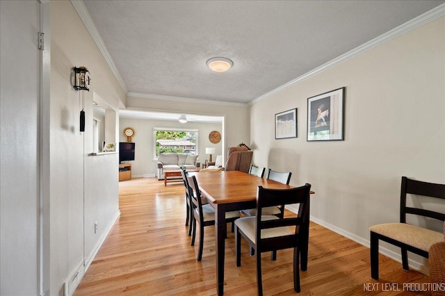 1731 Garfield Ave, Aurora, IL 60506 - dining space with light wood-type flooring, ornamental molding, baseboards, and a textured ceiling
