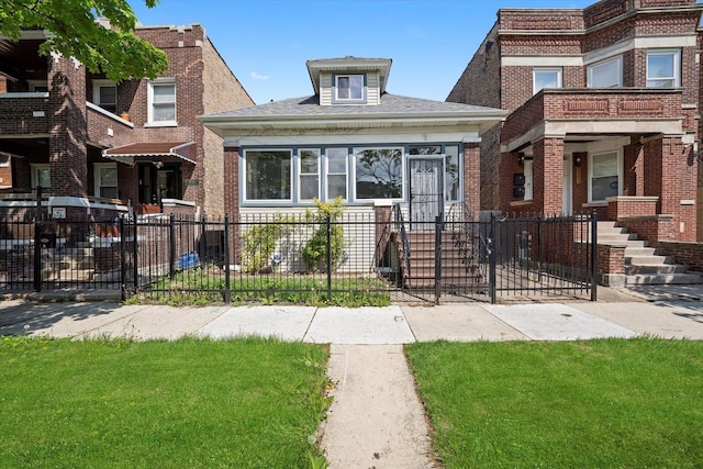 view of front of home with a fenced front yard and brick siding