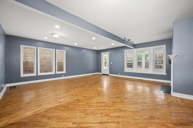 unfurnished living room with light wood-style flooring, recessed lighting, and beamed ceiling