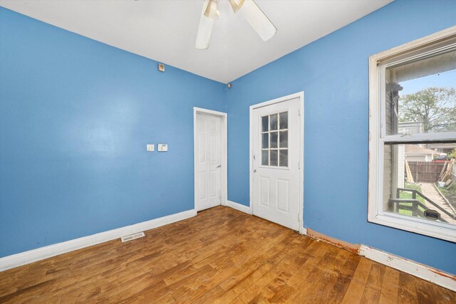 unfurnished room with wood finished floors and ceiling fan
