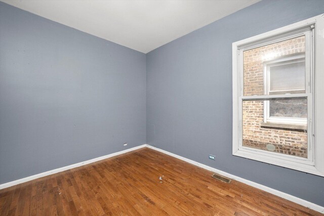 spare room featuring wood finished floors