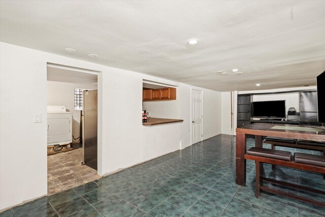 living room with washer / dryer and recessed lighting