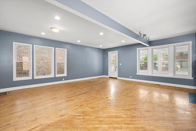unfurnished living room with wood finished floors and recessed lighting