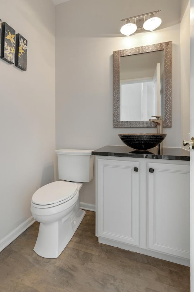 119 Allerton Dr, Schaumburg, IL 60194 - half bath featuring toilet, baseboards, wood finished floors, and vanity