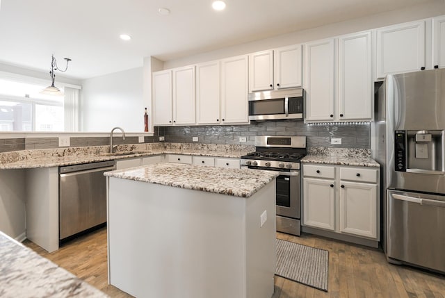 119 Allerton Dr, Schaumburg, IL 60194 - kitchen featuring appliances with stainless steel finishes, a sink, decorative backsplash, recessed lighting, and light stone counters