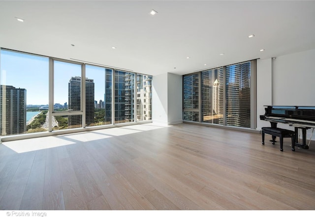 363 E Wacker Dr Unit 1903, Chicago, IL 60601 - unfurnished room featuring a wall of windows, wood finished floors, and a water view