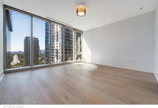 363 E Wacker Dr Unit 1903, Chicago, IL 60601 - empty room with wood finished floors, baseboards, floor to ceiling windows, and a view of city