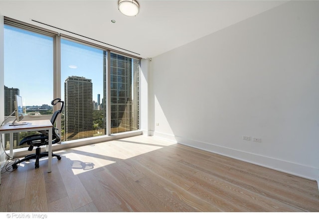 363 E Wacker Dr Unit 1903, Chicago, IL 60601 - office featuring expansive windows, wood finished floors, baseboards, and a city view