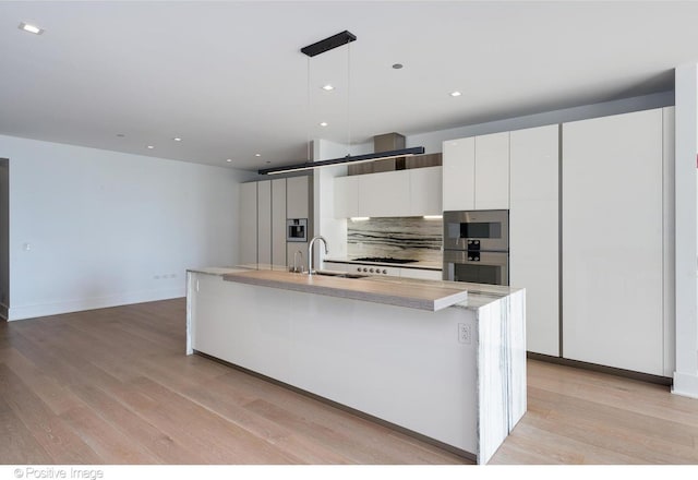 363 E Wacker Dr Unit 1903, Chicago, IL 60601 - kitchen with decorative backsplash, modern cabinets, a sink, white cabinetry, and light wood-style floors