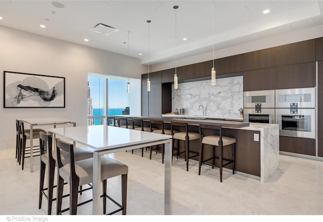 363 E Wacker Dr Unit 1903, Chicago, IL 60601 - kitchen featuring backsplash, modern cabinets, a large island, recessed lighting, and dark brown cabinetry