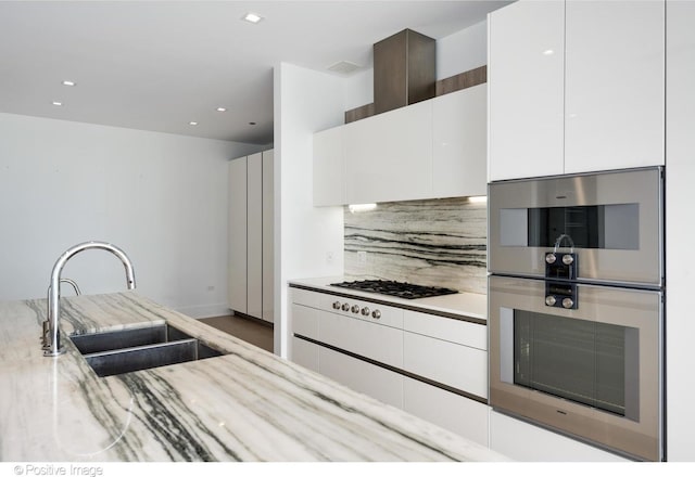 363 E Wacker Dr Unit 1903, Chicago, IL 60601 - kitchen featuring a sink, stainless steel double oven, white gas stovetop, tasteful backsplash, and white cabinets