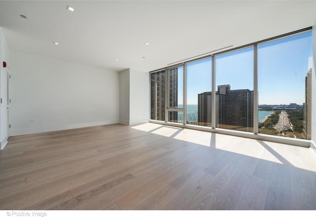 363 E Wacker Dr Unit 1903, Chicago, IL 60601 - empty room featuring wood finished floors, expansive windows, a water view, and baseboards