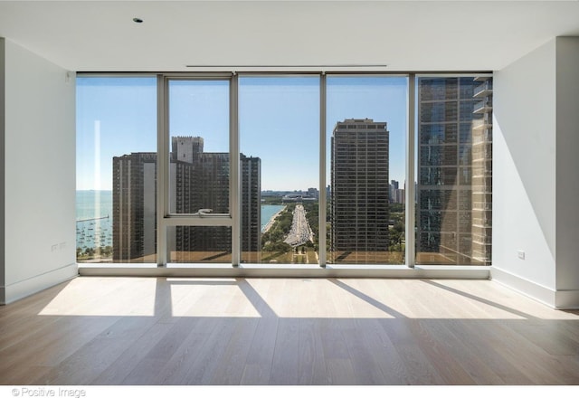 363 E Wacker Dr Unit 1903, Chicago, IL 60601 - empty room featuring expansive windows, wood finished floors, baseboards, and a water view