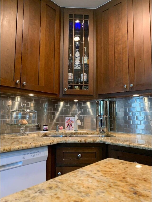 8632 New England Ave, Burbank, IL 60459 - kitchen with white dishwasher, a sink, glass insert cabinets, and decorative backsplash
