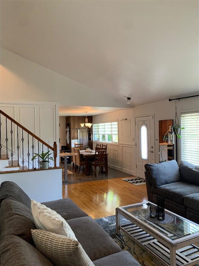 8632 New England Ave, Burbank, IL 60459 - living room with a decorative wall, wood finished floors, stairway, a wainscoted wall, and a chandelier