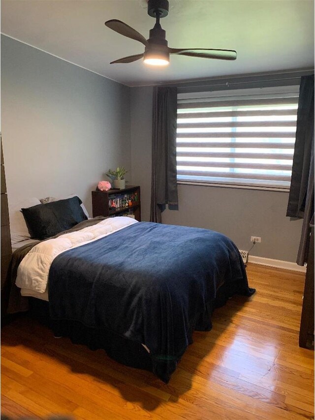 8632 New England Ave, Burbank, IL 60459 - bedroom featuring wood finished floors, a ceiling fan, and baseboards