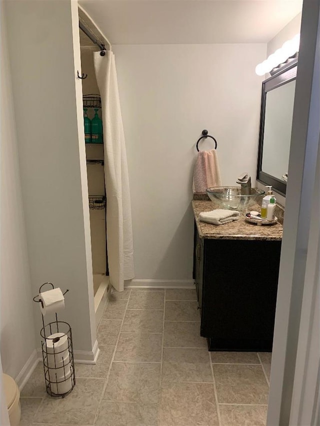 8632 New England Ave, Burbank, IL 60459 - bathroom featuring vanity, a shower stall, toilet, tile patterned flooring, and baseboards