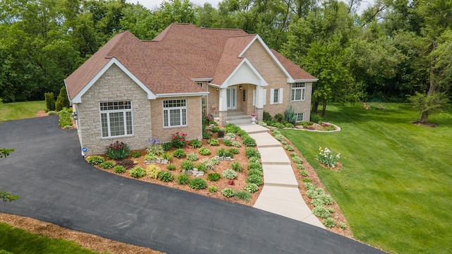 5419 Rita Ave, Crystal Lake, IL 60014 - view of front of house featuring stone siding, a front lawn, and roof with shingles