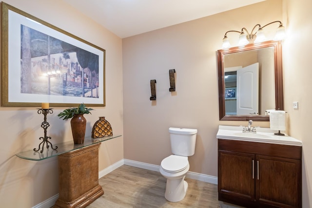5419 Rita Ave, Crystal Lake, IL 60014 - half bathroom featuring wood finished floors, toilet, baseboards, and vanity