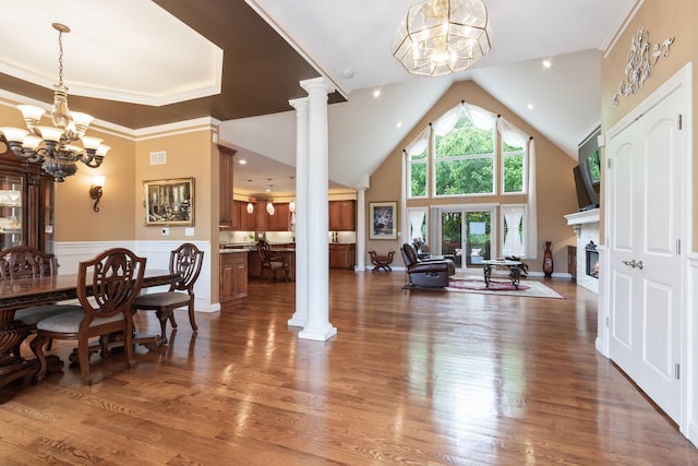 5419 Rita Ave, Crystal Lake, IL 60014 - dining room featuring a chandelier, decorative columns, a fireplace, wood finished floors, and high vaulted ceiling