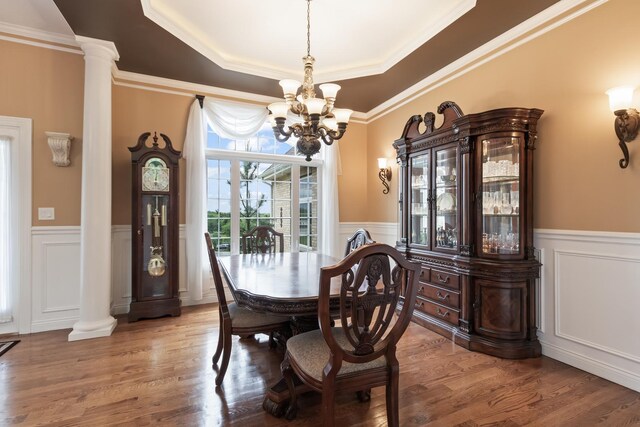 5419 Rita Ave, Crystal Lake, IL 60014 - dining room featuring decorative columns, a decorative wall, a chandelier, wainscoting, and a raised ceiling
