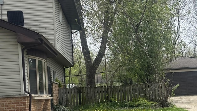 331 Somonauk St, Park Forest, IL 60466 - view of side of property featuring a garage, fence, and driveway