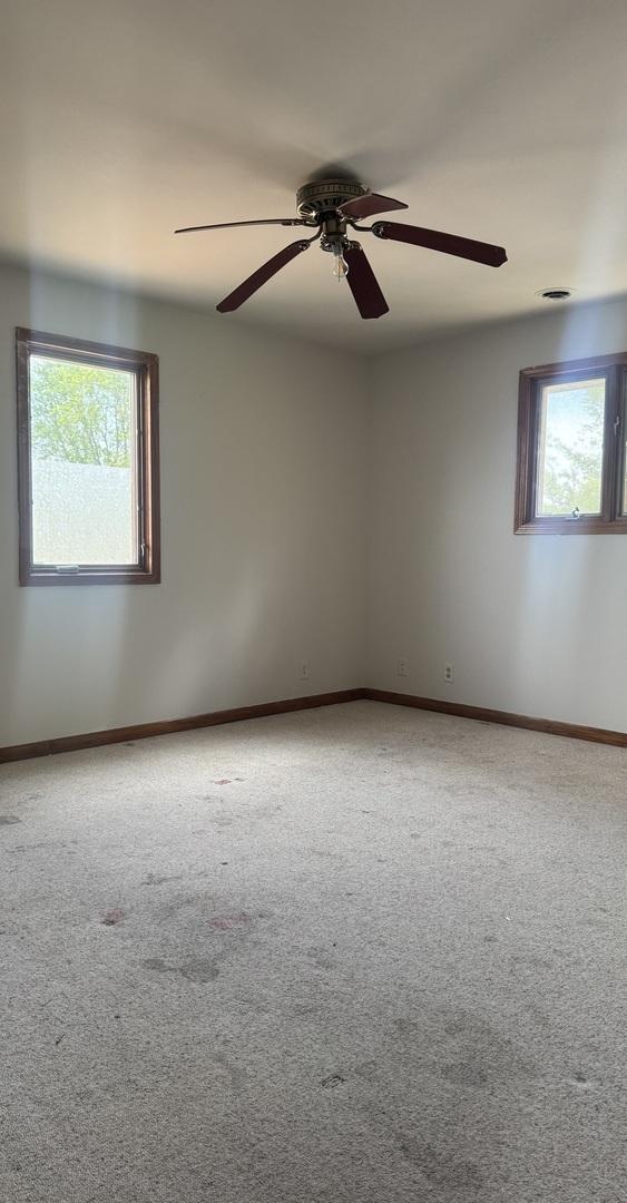331 Somonauk St, Park Forest, IL 60466 - carpeted spare room with a ceiling fan and baseboards
