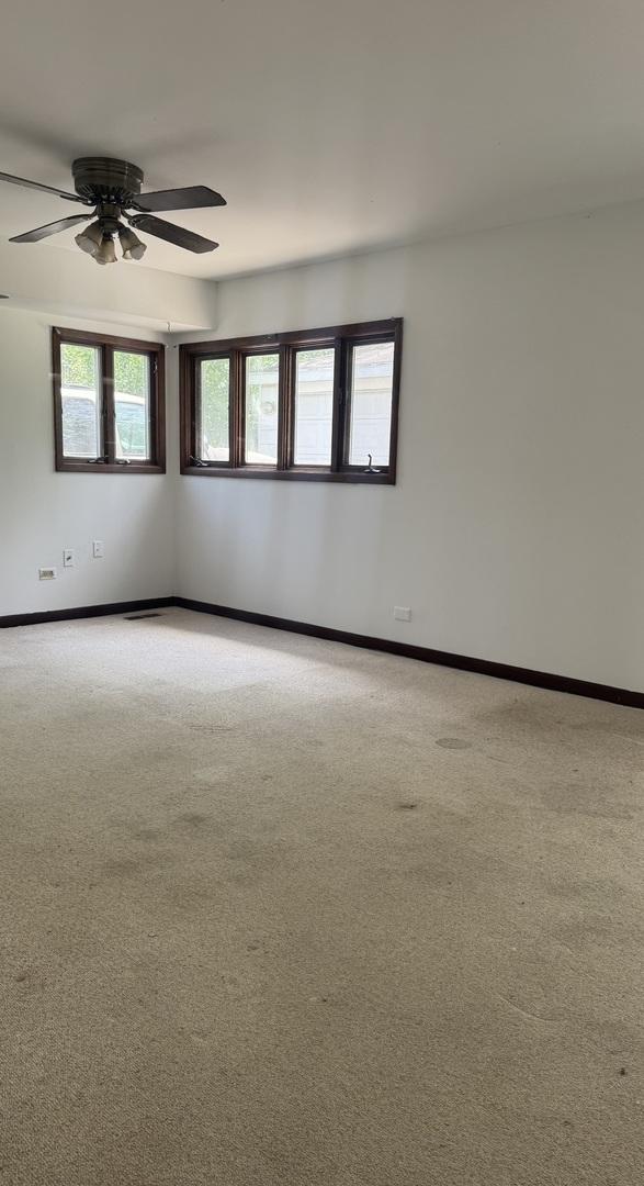 331 Somonauk St, Park Forest, IL 60466 - spare room with light colored carpet, ceiling fan, and baseboards