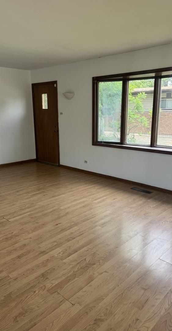 331 Somonauk St, Park Forest, IL 60466 - empty room with baseboards and light wood-type flooring