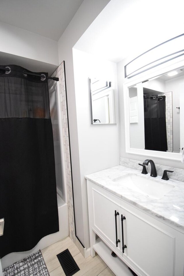 378 Wilmington Dr Unit B1, Bartlett, IL 60103 - bathroom featuring vanity and shower / bath combo with shower curtain