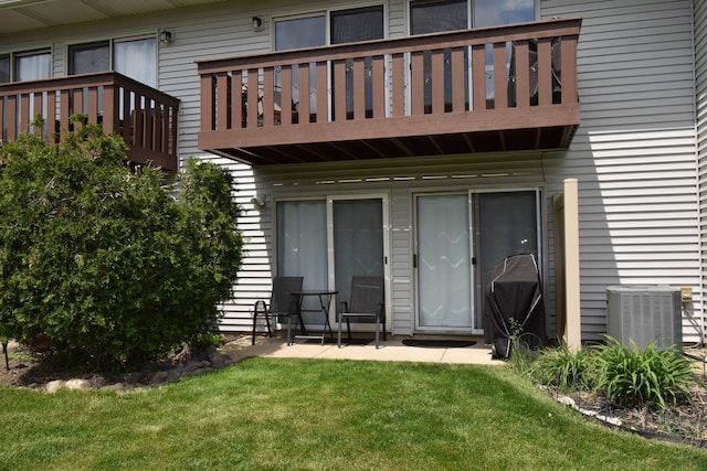 378 Wilmington Dr Unit B1, Bartlett, IL 60103 - rear view of property featuring a balcony, central AC unit, and a yard