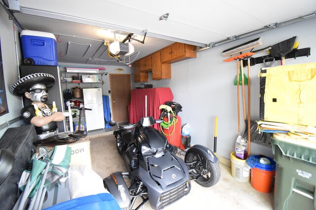 378 Wilmington Dr Unit B1, Bartlett, IL 60103 - garage with freestanding refrigerator and a garage door opener