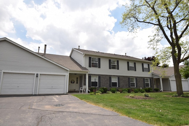 378 Wilmington Dr Unit B1, Bartlett, IL 60103 - view of front of house with an attached garage, driveway, a front yard, and a shingled roof