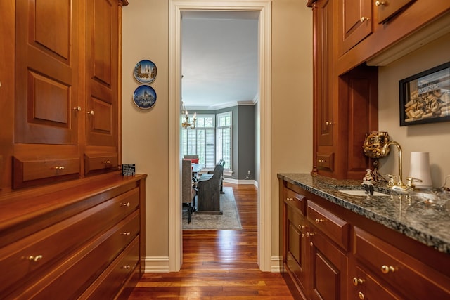 9430 Reserve Dr, Caledonia, IL 61011 - corridor with dark wood-style flooring, crown molding, baseboards, and a chandelier