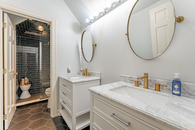 9430 Reserve Dr, Caledonia, IL 61011 - bathroom featuring two vanities, toilet, tile patterned flooring, and a tile shower