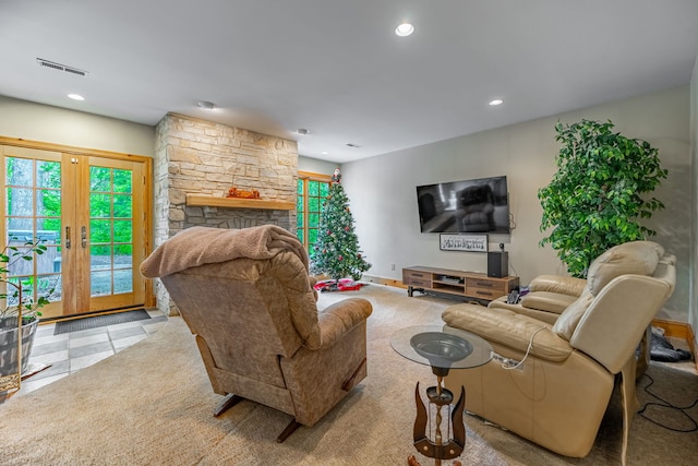 9430 Reserve Dr, Caledonia, IL 61011 - living room with healthy amount of natural light, recessed lighting, a stone fireplace, baseboards, and tile patterned flooring