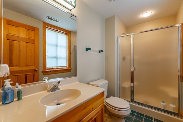 9430 Reserve Dr, Caledonia, IL 61011 - bathroom with a stall shower, toilet, vanity, and tile patterned flooring