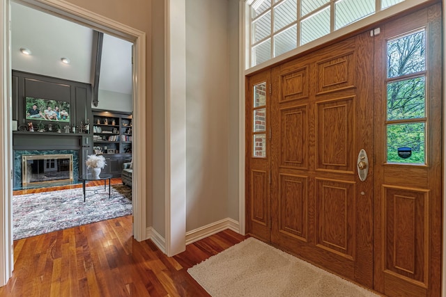 9430 Reserve Dr, Caledonia, IL 61011 - entryway with dark wood-style flooring, baseboards, and a premium fireplace