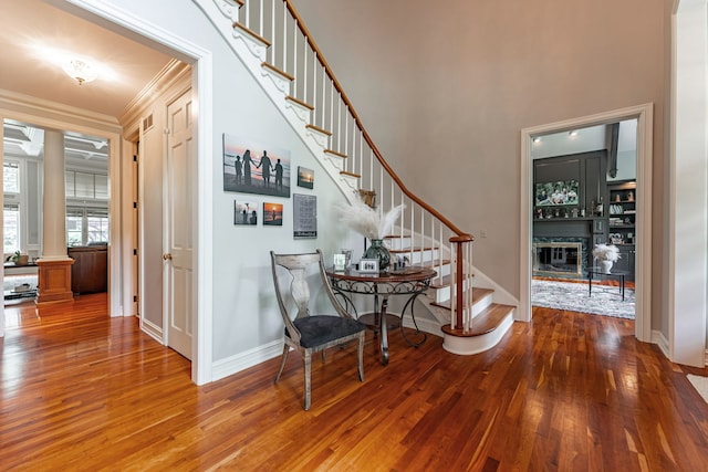 9430 Reserve Dr, Caledonia, IL 61011 - entryway featuring stairway, wood finished floors, ornamental molding, baseboards, and a glass covered fireplace