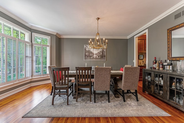 9430 Reserve Dr, Caledonia, IL 61011 - dining space with a chandelier, wood finished floors, and crown molding