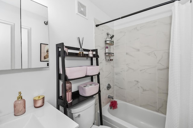 full bathroom featuring shower / tub combo with curtain and toilet
