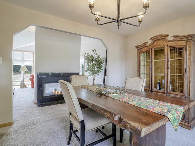 1372 Pheasant Chase Cir, Beecher, IL 60401 - dining area featuring carpet floors, a chandelier, a multi sided fireplace, and arched walkways