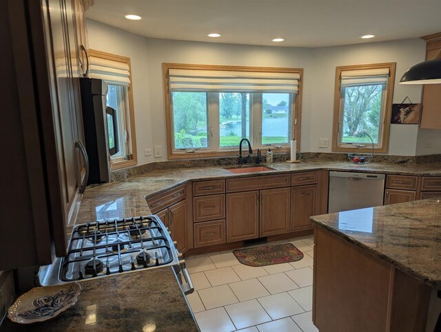 1372 Pheasant Chase Cir, Beecher, IL 60401 - kitchen with appliances with stainless steel finishes, dark stone counters, recessed lighting, light tile patterned floors, and brown cabinets